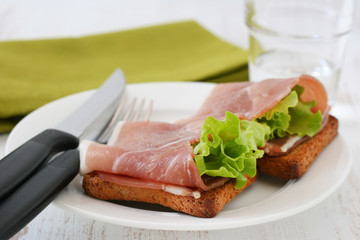 toasts with prosciutto and lettuce