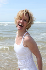 Blond woman having fun at the beach