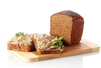 Fresh pate on bread on wooden board isolated on white
