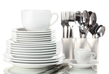 Clean plates, cup and cutlery isolated on white