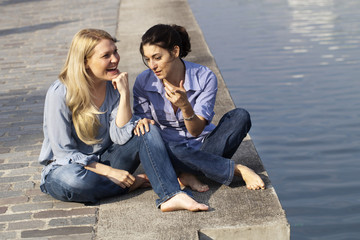 girlfriends chatting next to the water
