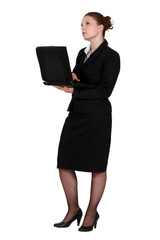 A pensive businesswoman with a laptop.