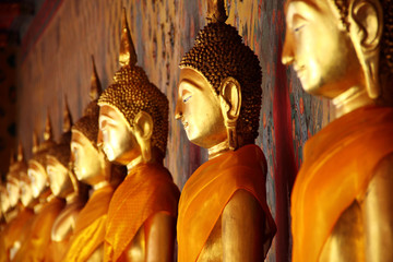 golden Buddha image arrange in arcade, Bangkok, Thailand