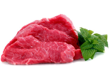 Cut of  beef steak with green leaf. Isolated.