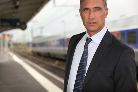 portrait of a businessman at train station