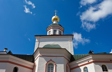 Fototapeta na wymiar The Tower of the Russian Church on blue sky background