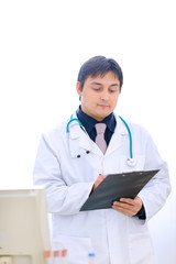 Medical doctor writing something in clipboard