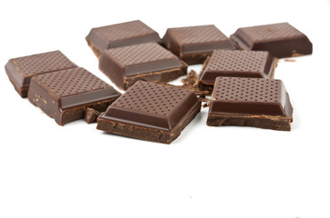 Broken chocolate over white