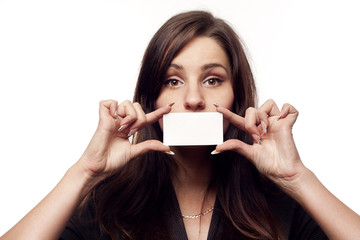 Young businesswoman holding empty blank over her lips