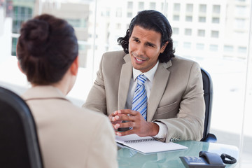 Smiling manager interviewing a female applicant