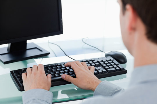 Back View Of A Manager Working With A Monitor