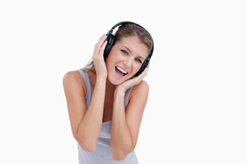 Naklejka premium Woman singing while listening to music