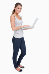 Fototapeta premium Portrait of a smiling woman using a laptop