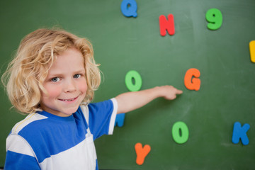 Schoolboy pointing at a letter