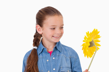 Girl looking at a flower