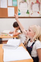 Portrait of a pupil raising her hand