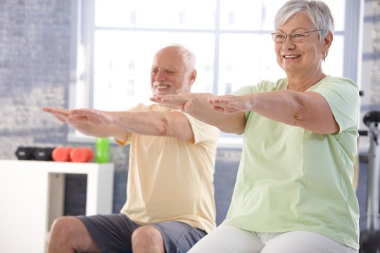 Mature people exercising happily