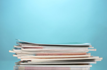 stack of magazines on blue background