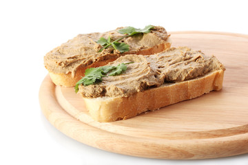 Fresh pate on bread on wooden board