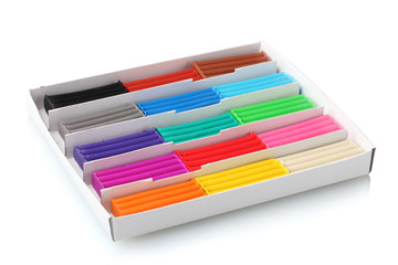 Children bright plasticine in a paper box isolated on white