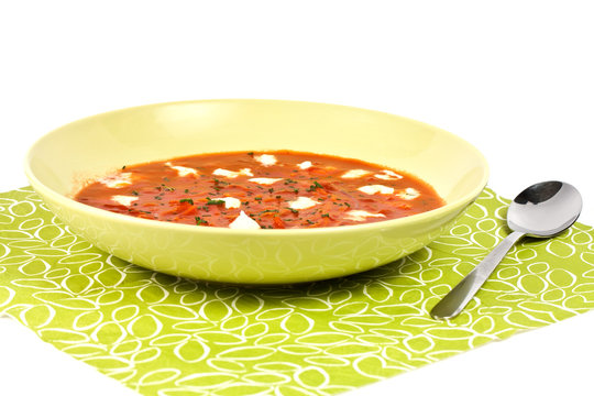 Tomato soop with chopped parsley and mozzarella cheese