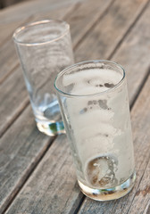 Two empty beer glasses on a wooden table