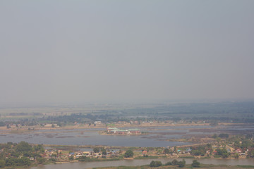 Fog over the city where the sun shines down from the clouds.