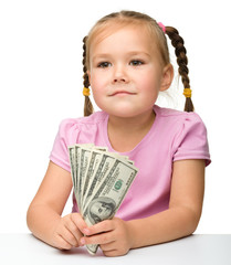 Cute little girl with paper money - dollars