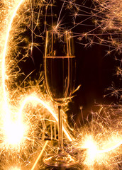 New Year's bengal fire and champagne on a black background