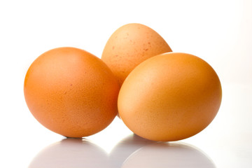 three brown eggs isolated on white