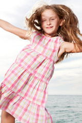 Girl enjoys summer day at the beach.