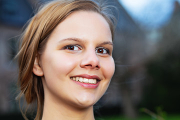 Fototapeta premium Head portrait of a young smiling woman