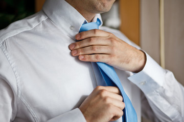 Groom set  the tie straight