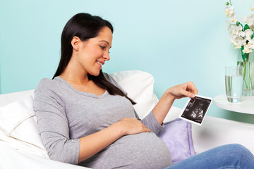 Pregnant woman looking at baby scan