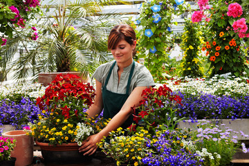 young female gardener in the greenhouse