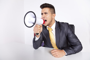 .Businessman shouting with a megaphone