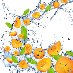 Obraz na płótnie Canvas Fresh apricots falling in water splash