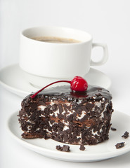 Cup of coffee and chocolate dessert with a cherry