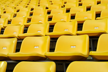Fototapeta premium Yellow Empty plastic seats at stadium