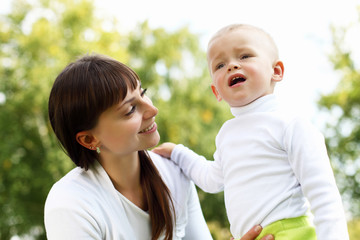 Fototapeta premium Young mother with her son in summer park