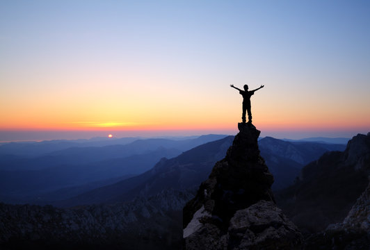 Silhouette Of Men On Top Of The Mountain