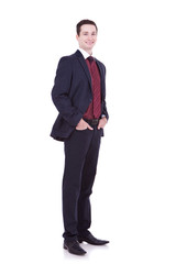 business man standing with hands in pocket