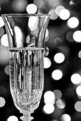 sparkling wine in a crystal glass surrounded by festive lights