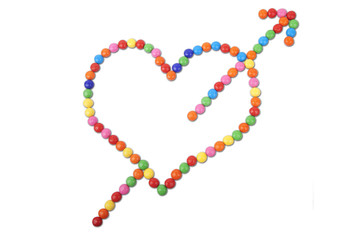 Heart made of colorful candy with arrow