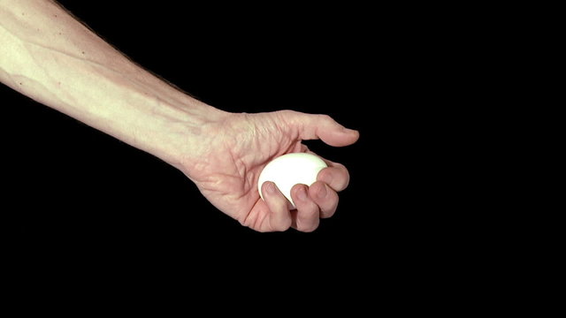 Hand crushing an egg. Slow motion