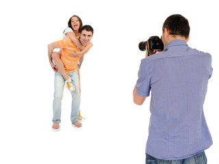 professional male photographer making family picture at studio.