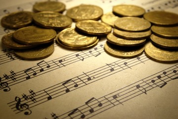 coins on a musical notebook
