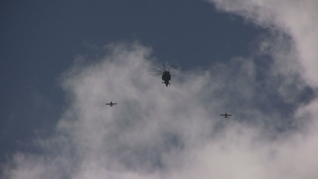 Helicopter and airplanes in formation