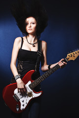 Obraz premium Beautiful dancing girl with a guitar