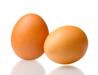 two brown eggs isolated on white